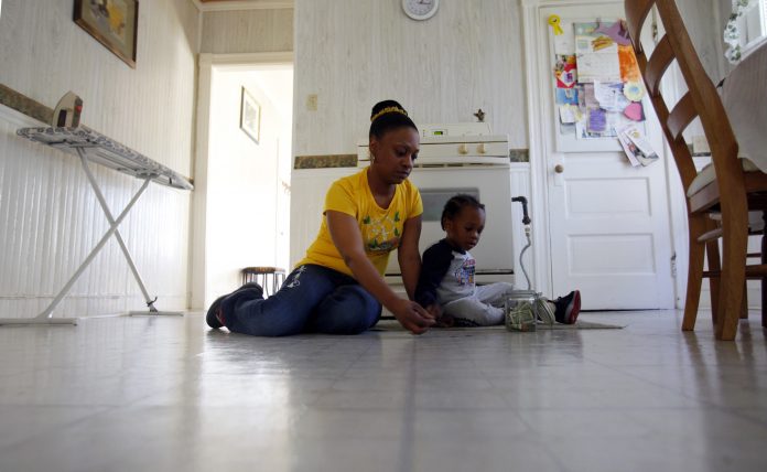 April Metts plays with her two-year old son Jamar at her apartment in Providence